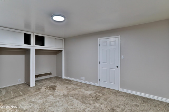 unfurnished bedroom featuring carpet flooring and baseboards