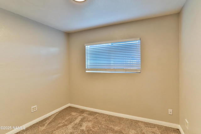 carpeted empty room with baseboards