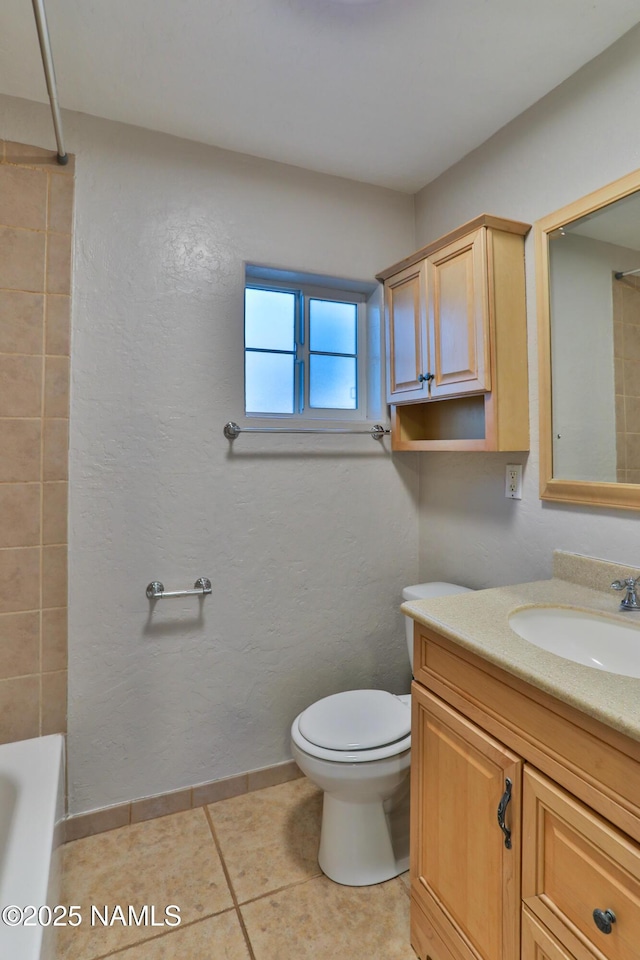 full bath featuring toilet, vanity, baseboards, and tile patterned floors