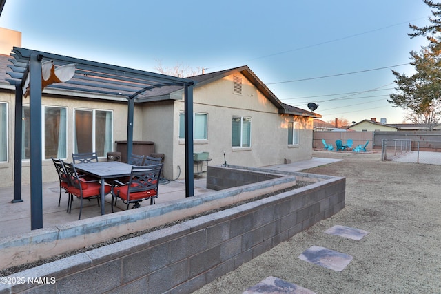 back of house featuring a patio, fence, outdoor dining area, a pergola, and stucco siding