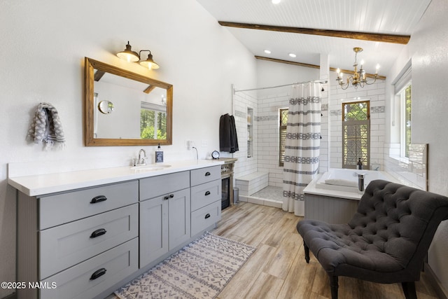 7530 N Rain Valley Rd, Flagstaff, AZ 86004 - bathroom with a tile shower, a chandelier, vanity, wood finished floors, and a garden tub
