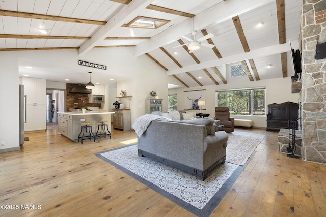 7530 N Rain Valley Rd, Flagstaff, AZ 86004 - living room featuring a wood stove, light wood-style floors, ceiling fan, recessed lighting, and high vaulted ceiling