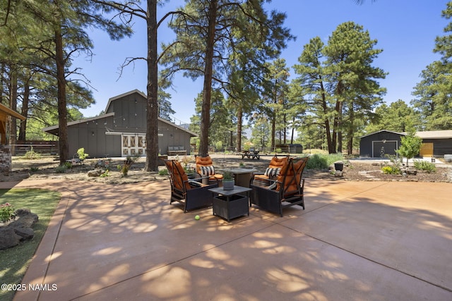 7530 N Rain Valley Rd, Flagstaff, AZ 86004 - view of patio with an outdoor hangout area, an outbuilding, and a barn