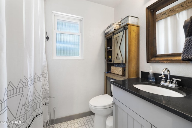 7530 N Rain Valley Rd, Flagstaff, AZ 86004 - bathroom featuring toilet, vanity, curtained shower, tile patterned floors, and baseboards