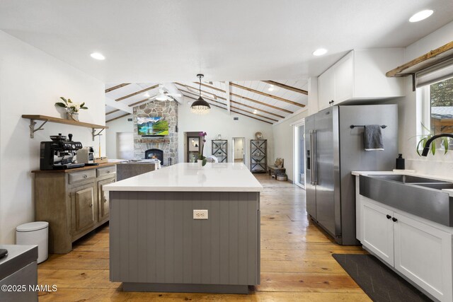7530 N Rain Valley Rd, Flagstaff, AZ 86004 - kitchen with open floor plan, white cabinetry, stainless steel refrigerator with ice dispenser, a center island, and recessed lighting