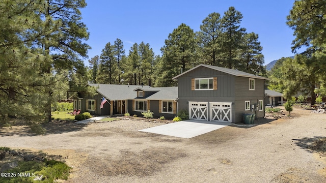 7530 N Rain Valley Rd, Flagstaff, AZ 86004 - view of front of house with an attached garage, driveway, and board and batten siding