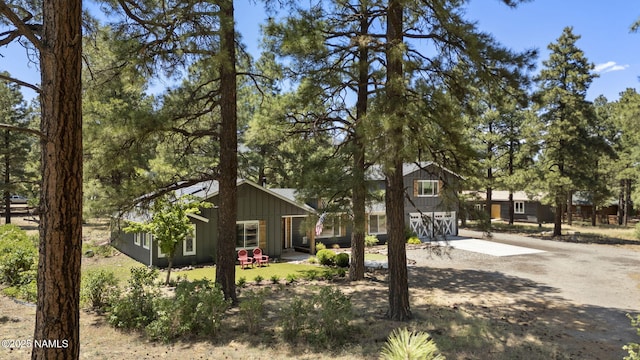 7530 N Rain Valley Rd, Flagstaff, AZ 86004 - view of front facade with concrete driveway and board and batten siding