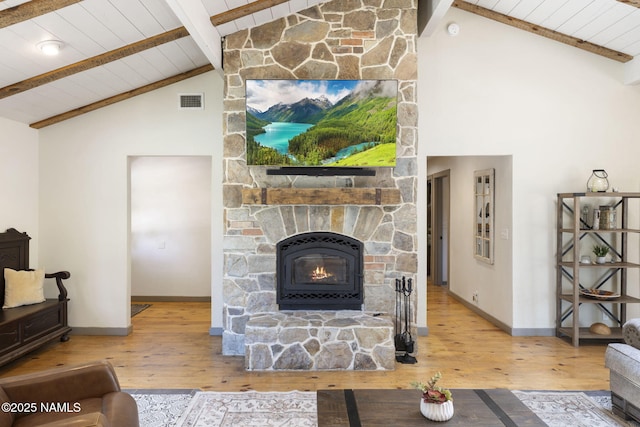 7530 N Rain Valley Rd, Flagstaff, AZ 86004 - living area featuring wood ceiling with exposed beams, baseboards, wood-type flooring, a stone fireplace, and high vaulted ceiling