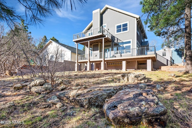 673 N Pine Cliff Dr, Flagstaff, AZ 86001 - back of property with a chimney, stairs, and a deck