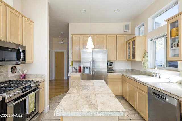 673 N Pine Cliff Dr, Flagstaff, AZ 86001 - kitchen with ceiling fan, light brown cabinetry, appliances with stainless steel finishes, a center island, and a sink