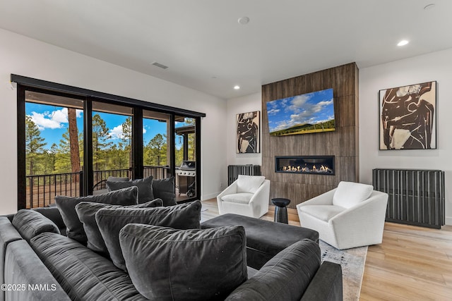 2625 S Cottonrose Ln, Flagstaff, AZ 86005 - living room with a fireplace, light wood finished floors, recessed lighting, and baseboards