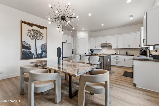 2625 S Cottonrose Ln, Flagstaff, AZ 86005 - dining area with a chandelier, light wood-style floors, recessed lighting, and baseboards