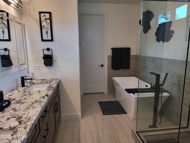 2625 S Cottonrose Ln, Flagstaff, AZ 86005 - full bathroom featuring vanity, a stall shower, a freestanding bath, and baseboards