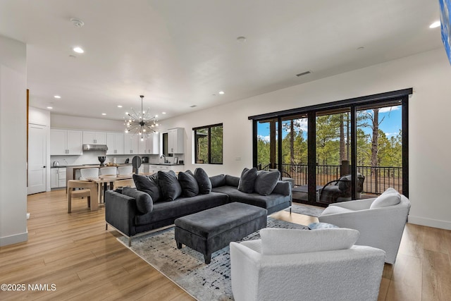 2625 S Cottonrose Ln, Flagstaff, AZ 86005 - living area featuring a chandelier, recessed lighting, light wood finished floors, and baseboards