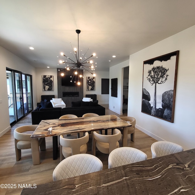 2625 S Cottonrose Ln, Flagstaff, AZ 86005 - dining area with light wood-style flooring, a chandelier, baseboards, and recessed lighting