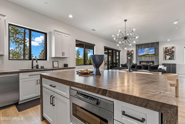 2625 S Cottonrose Ln, Flagstaff, AZ 86005 - kitchen with a sink, dishwasher, wood counters, recessed lighting, and light wood-style flooring