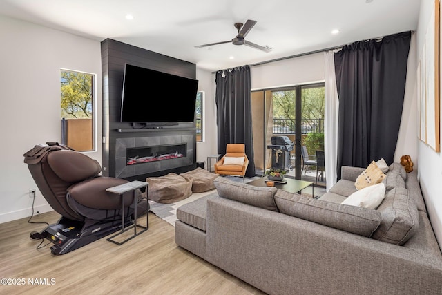10299 E White Feather Ln, Scottsdale, AZ 85262 - living area with recessed lighting, light wood-style floors, a large fireplace, and a ceiling fan