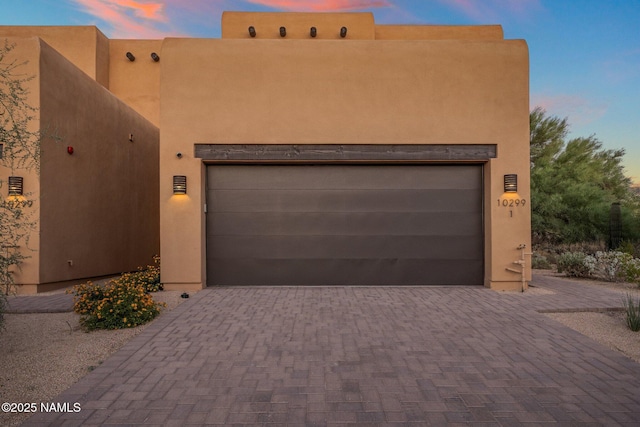 10299 E White Feather Ln, Scottsdale, AZ 85262 - pueblo-style house featuring driveway, a garage, and stucco siding