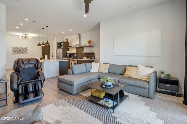 10299 E White Feather Ln, Scottsdale, AZ 85262 - living area featuring recessed lighting, ceiling fan, light wood-style flooring, and a chandelier