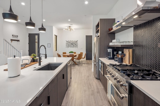 10299 E White Feather Ln, Scottsdale, AZ 85262 - kitchen with wall chimney exhaust hood, appliances with stainless steel finishes, light countertops, modern cabinets, and recessed lighting