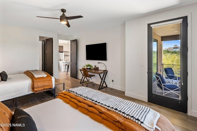 10299 E White Feather Ln, Scottsdale, AZ 85262 - bedroom featuring access to outside, wood finished floors, ceiling fan, and freestanding refrigerator