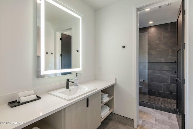 10299 E White Feather Ln, Scottsdale, AZ 85262 - bathroom featuring vanity, tiled shower, and recessed lighting