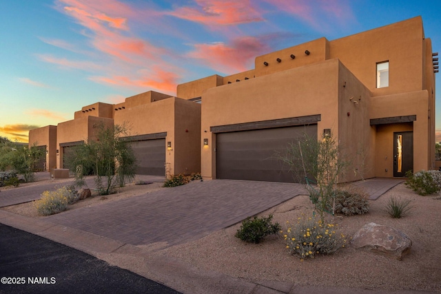 10299 E White Feather Ln, Scottsdale, AZ 85262 - pueblo-style home featuring stucco siding, driveway, and an attached garage