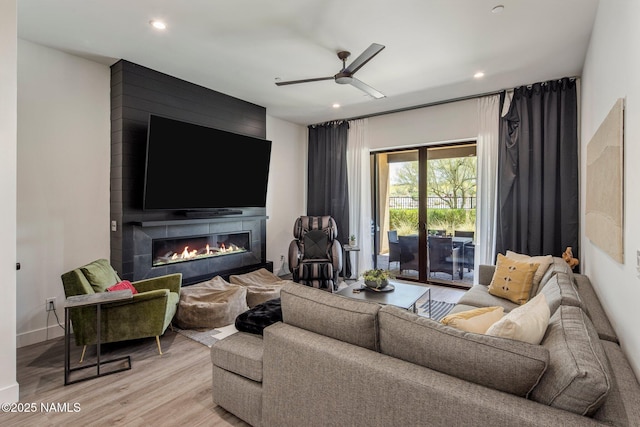 10299 E White Feather Ln, Scottsdale, AZ 85262 - living room with light wood-style floors, ceiling fan, a fireplace, and recessed lighting