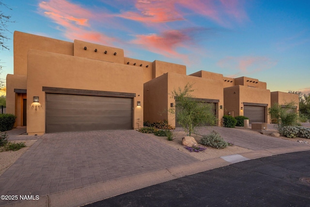 10299 E White Feather Ln, Scottsdale, AZ 85262 - southwest-style home featuring stucco siding, decorative driveway, and a garage