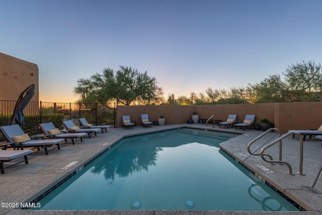 10299 E White Feather Ln, Scottsdale, AZ 85262 - pool at dusk featuring a patio and a community pool