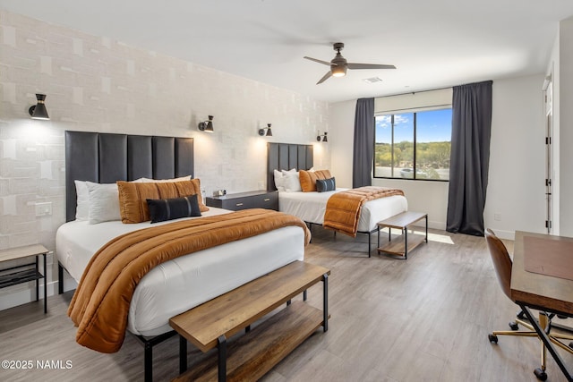 10299 E White Feather Ln, Scottsdale, AZ 85262 - bedroom with light wood finished floors and ceiling fan