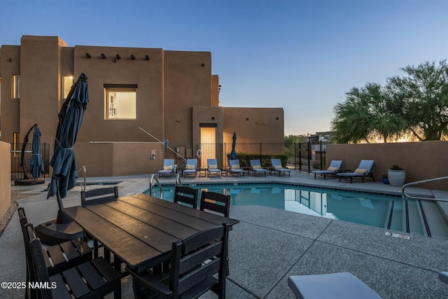 10299 E White Feather Ln, Scottsdale, AZ 85262 - pool at dusk featuring a patio and a community pool