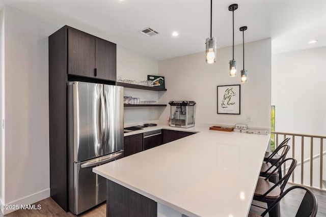 10299 E White Feather Ln, Scottsdale, AZ 85262 - kitchen with freestanding refrigerator, a peninsula, light countertops, a kitchen breakfast bar, and open shelves