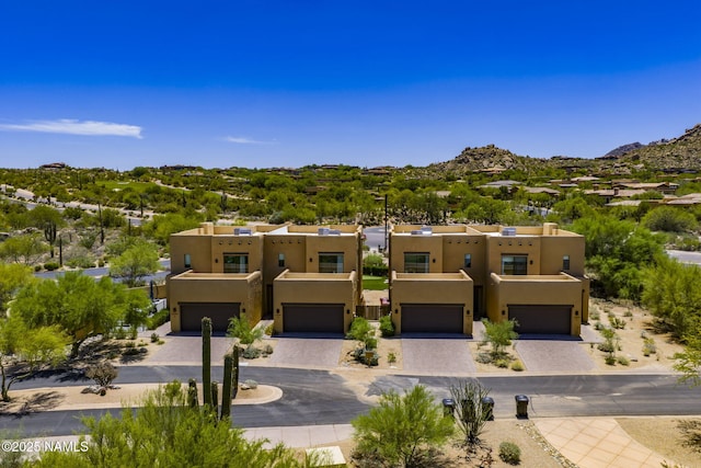 10299 E White Feather Ln, Scottsdale, AZ 85262 - adobe home with stucco siding, a garage, and driveway