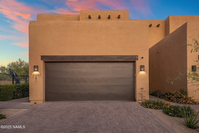 10299 E White Feather Ln, Scottsdale, AZ 85262 - pueblo revival-style home with decorative driveway and stucco siding