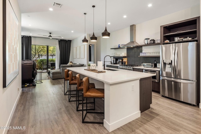 10299 E White Feather Ln, Scottsdale, AZ 85262 - kitchen with stainless steel fridge, ventilation hood, open shelves, light countertops, and recessed lighting