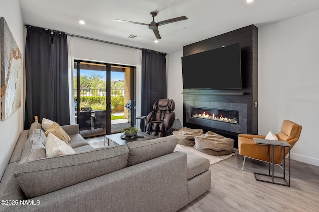 10299 E White Feather Ln, Scottsdale, AZ 85262 - living area with a fireplace, wood finished floors, a ceiling fan, and recessed lighting