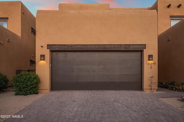 10299 E White Feather Ln, Scottsdale, AZ 85262 - pueblo revival-style home featuring driveway, a garage, and stucco siding