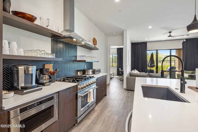 10299 E White Feather Ln, Scottsdale, AZ 85262 - kitchen with appliances with stainless steel finishes, wall chimney exhaust hood, open shelves, modern cabinets, and light countertops
