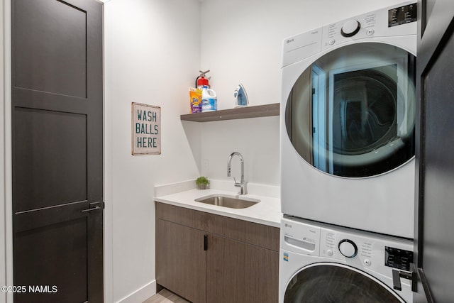 10299 E White Feather Ln, Scottsdale, AZ 85262 - laundry area featuring stacked washing machine and dryer and cabinet space