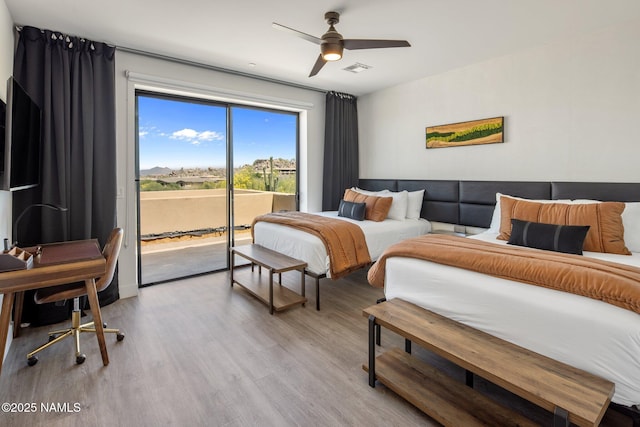 10299 E White Feather Ln, Scottsdale, AZ 85262 - bedroom with access to outside, light wood-type flooring, and ceiling fan