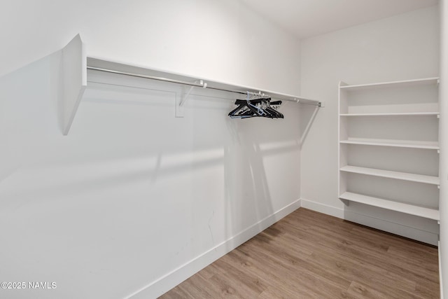 10299 E White Feather Ln, Scottsdale, AZ 85262 - spacious closet featuring wood finished floors