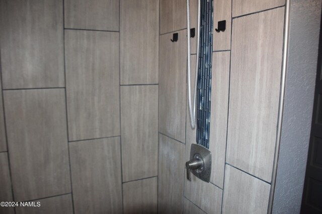 interior details with a tile shower