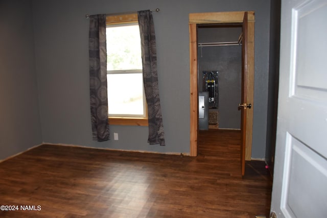 unfurnished bedroom with a closet and dark hardwood / wood-style floors