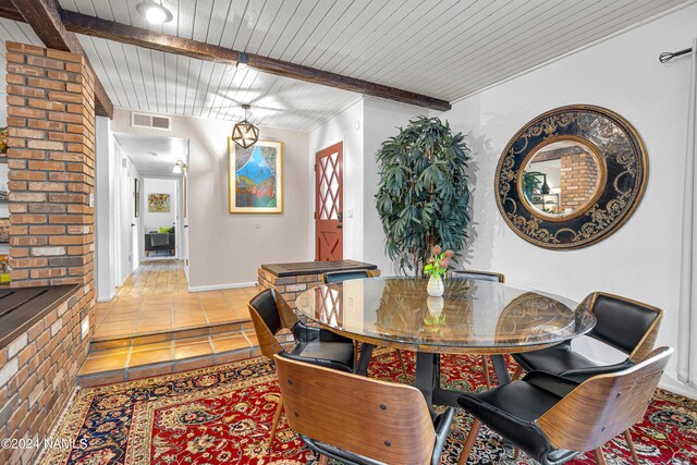 tiled dining room with beamed ceiling and wood ceiling