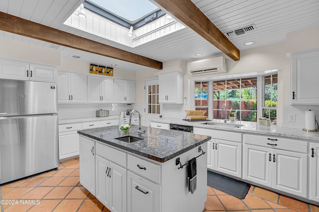 kitchen featuring sink, white cabinets, and stainless steel refrigerator