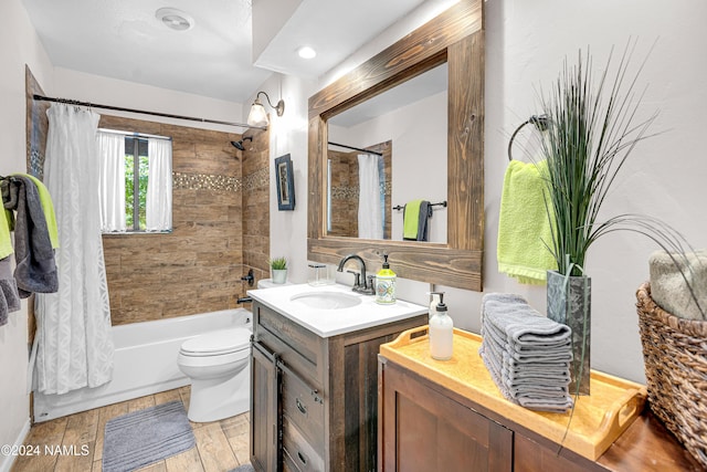 full bathroom featuring wood-type flooring, toilet, shower / tub combo with curtain, and vanity