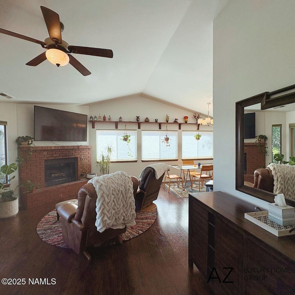 2630 N Eddy Dr, Flagstaff, AZ 86001 - living area with plenty of natural light, vaulted ceiling, dark wood finished floors, a fireplace, and ceiling fan