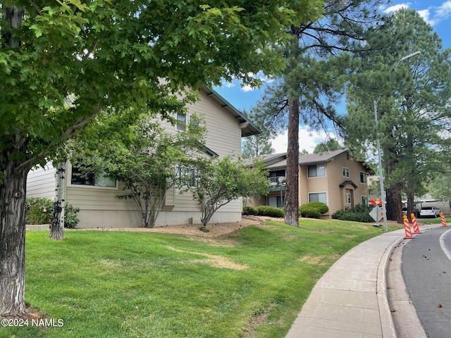 view of side of home with a lawn