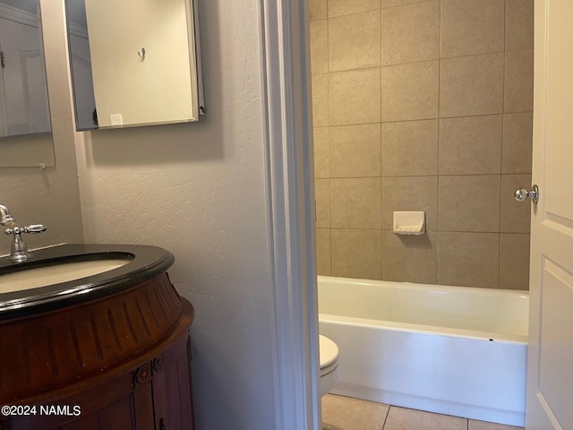 full bathroom featuring toilet, tiled shower / bath, tile patterned floors, and vanity